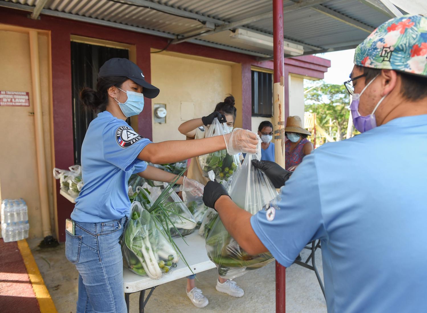AmeriCorps Guam members organize bags of produce for Guahan Sustainable Culture's drive-thru service at the Guam Public Library System Archival Center in Barrigada, April 24, 2020.Free Produce 05