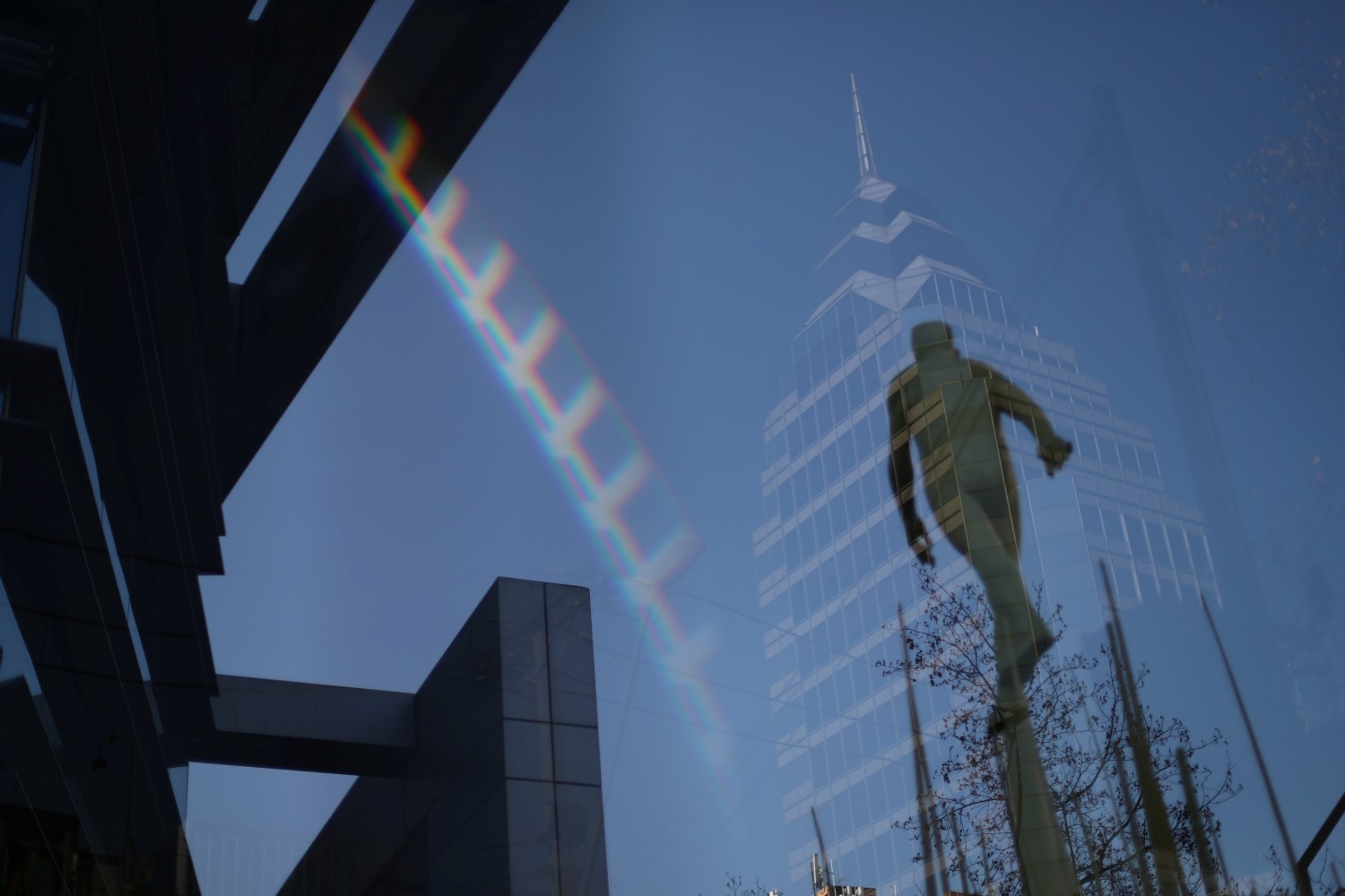 A building and a sculpture are reflected on glass in a wealthy neighborhood, during a general quarantine imposed due to a surge of fresh coronavirus disease (COVID-19) cases, in Santiago, Chile May 18, 2020. REUTERS/Ivan Alvarado
