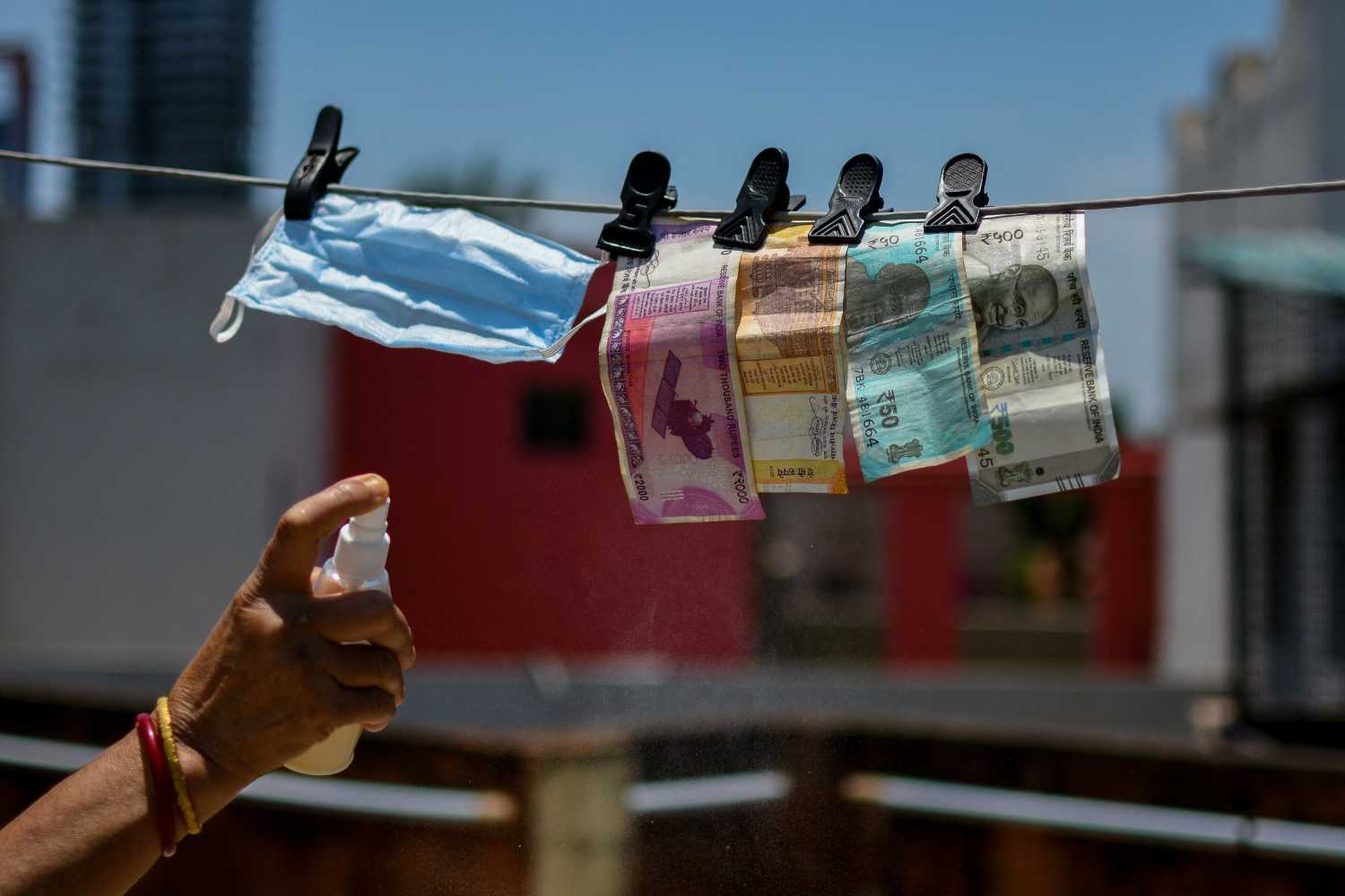 A lady disinfecting paper cash and mask in a household after her visit to a market place in Kolkata.Indias COVID-19 couint stands close to 50.000 as the country prepares to tackle community spread. Kolkata, India on May 6, 2020. Photo by Debarchan Chatterjee/ABACAPRESS.COM