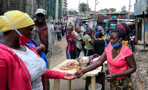 A woman sells fried chicken at her open stall along a street, amid the spread of the coronavirus disease (COVID-19) in Nairobi, Kenya April 19, 2020. REUTERS/Thomas Mukoya