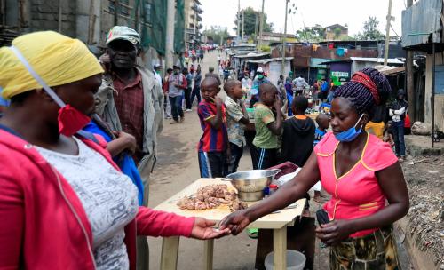 A woman sells fried chicken at her open stall along a street, amid the spread of the coronavirus disease (COVID-19) in Nairobi, Kenya April 19, 2020. REUTERS/Thomas Mukoya