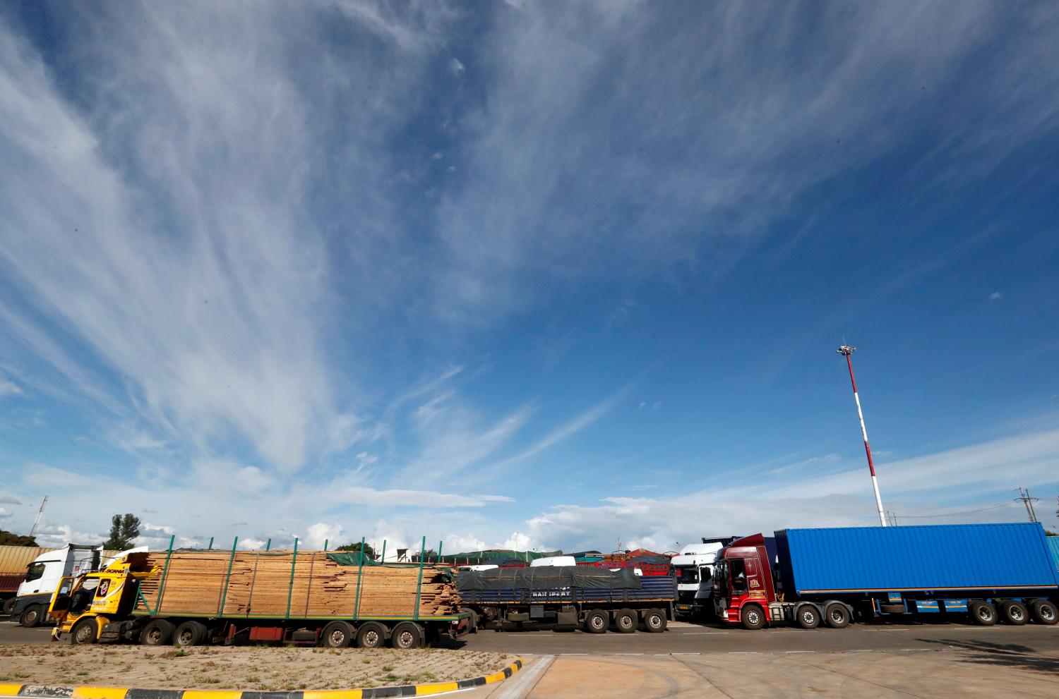 Trucks queue as their drivers undergo health screening, amid the spread of the coronavirus disease (COVID-19) outbreak at the Namanga one stop border crossing point between Kenya and Tanzania in Namanga, Kenya, May 12, 2020. Picture taken May 12, 2020. REUTERS/Thomas Mukoya