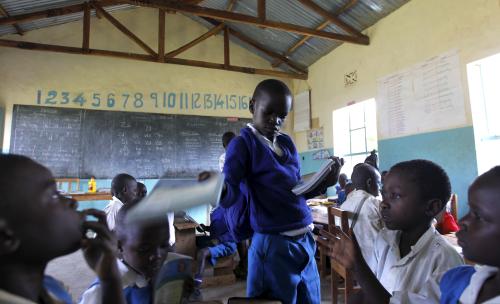 Seven year old Barack Obama, named after U.S. President Barack Obama distributes books to his classmates at the Senator Obama primary school in Nyangoma village in Kogelo west of Kenya's capital Nairobi, July 16, 2015. Obama visits Kenya and Ethiopia in July, his third major trip to Sub-Saharan Africa after travelling to Ghana in 2009 and to Tanzania, Senegal and South Africa in 2011. He has also visited Egypt, in North Africa, and South Africa for Nelson Mandela's funeral. Obama will be welcomed by a continent that had expected closer attention from a man they claim as their son, a sentiment felt acutely in the Kenyan village where the 44th U.S. president's father is buried. Picture taken July 16, 2015. REUTERS/Thomas Mukoya