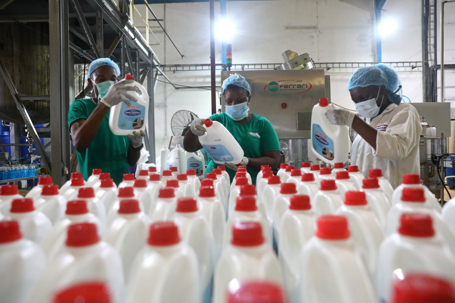 Employees inspect the production of hand sanitizers in Cormart factory as the company steps up production of hand sanitizers to prevent the spread of coronavirus disease (COVID-19), on the outskirts of Lagos, Nigeria March 19, 2020. Picture taken March 19, 2020. REUTERS/Temilade Adelaja