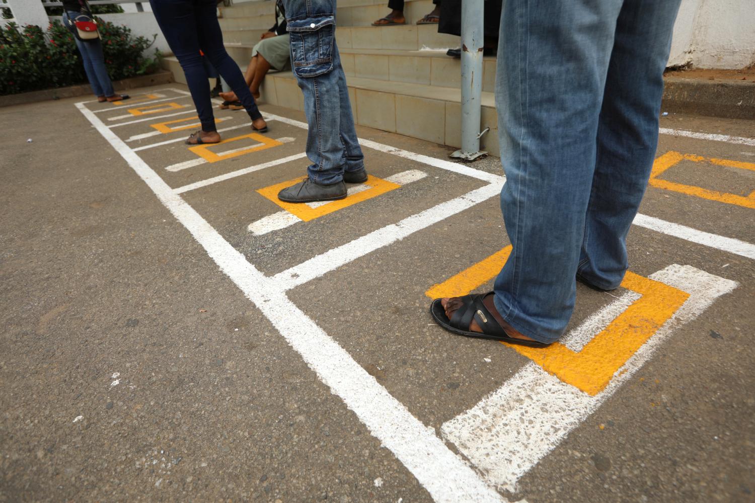 People stand within markings, as authorities ease the lockdown following the coronavirus disease (COVID-19) outbreak, in Abuja, Nigeria May 4, 2020. REUTERS/Afolabi Sotunde