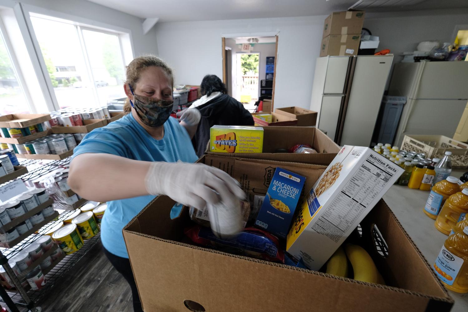 Christy Hagman prepares boxes of food at the C3 Church Food Pantry in Portland, Ore., on April 21, 2020. The pantry has seen demand triple as a result of the novel coronavirus but thanks to generous donations from larger grocery outlets they have been able to continue to provide an essential community service. (Photo by Alex Milan Tracy/Sipa USA)No Use UK. No Use Germany.