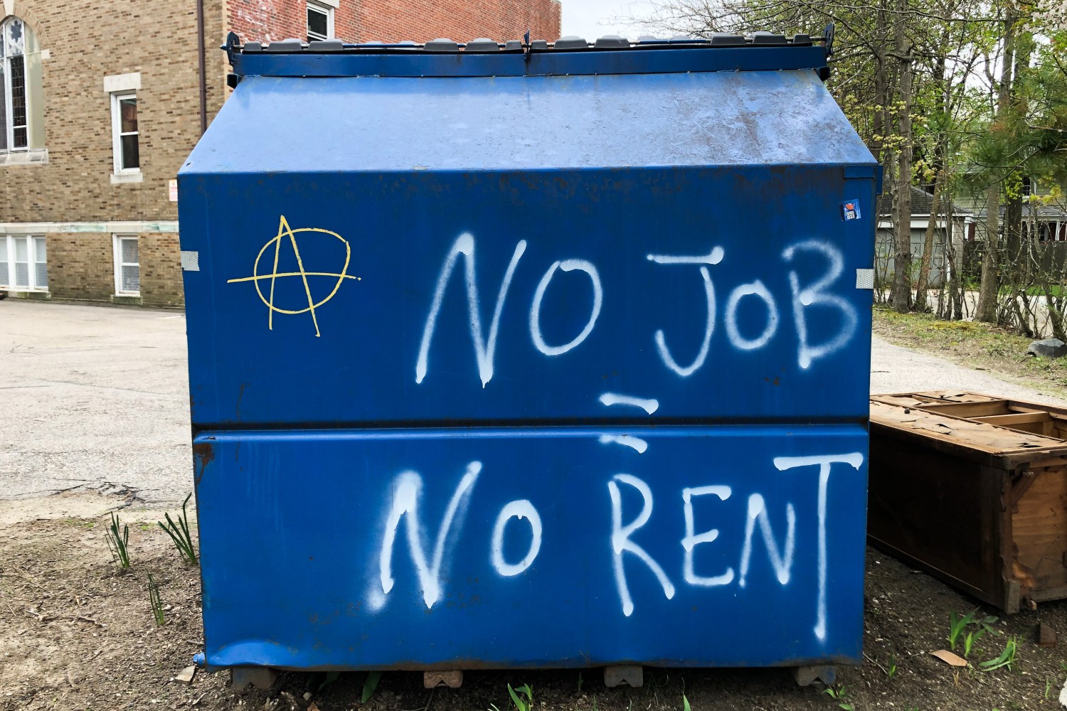 A garbage dumpster is painted with 'No Job No Rent' and the anarchy symbol in Providence, Rhode Island on May 4 2020. (Photo by Samuel Rigelhaupt / Sipa USA)No Use UK. No Use Germany.