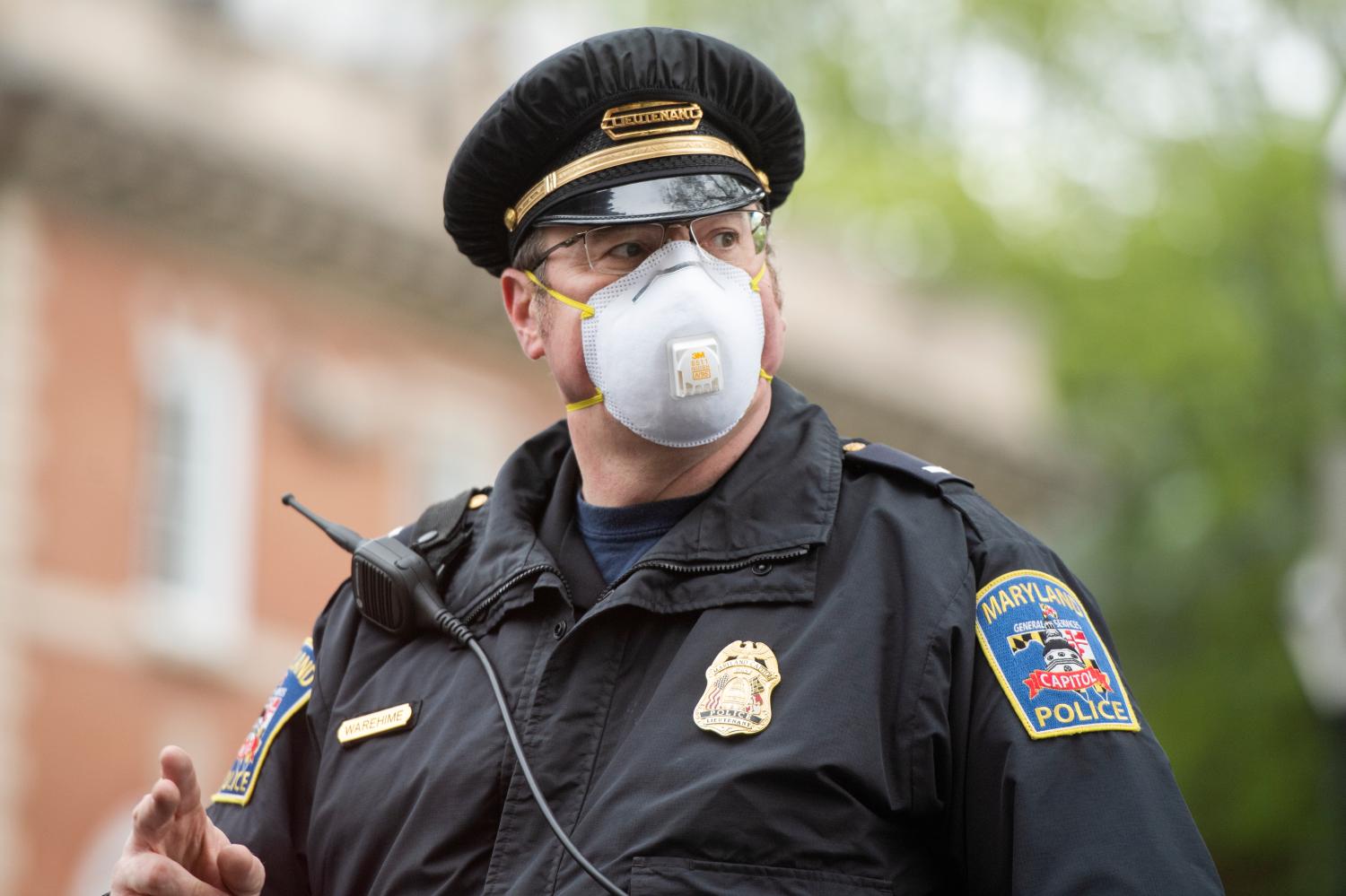 UNITED STATES - APRIL 18: A Maryland Capitol Police lieutenant oversees demonstrators demanding that Gov. Larry Hogan (R) lift restrictions that have closed certain businesses in Maryland since the coronavirus outbreak on Church Circle in Annapolis, Md., on Saturday, April 18, 2020. The event titled Operation Gridlock Annapolis was hosted by the Patriot Picket and Reopen Maryland. (Photo By Tom Williams/CQ Roll Call/Sipa USA)No Use UK. No Use Germany.