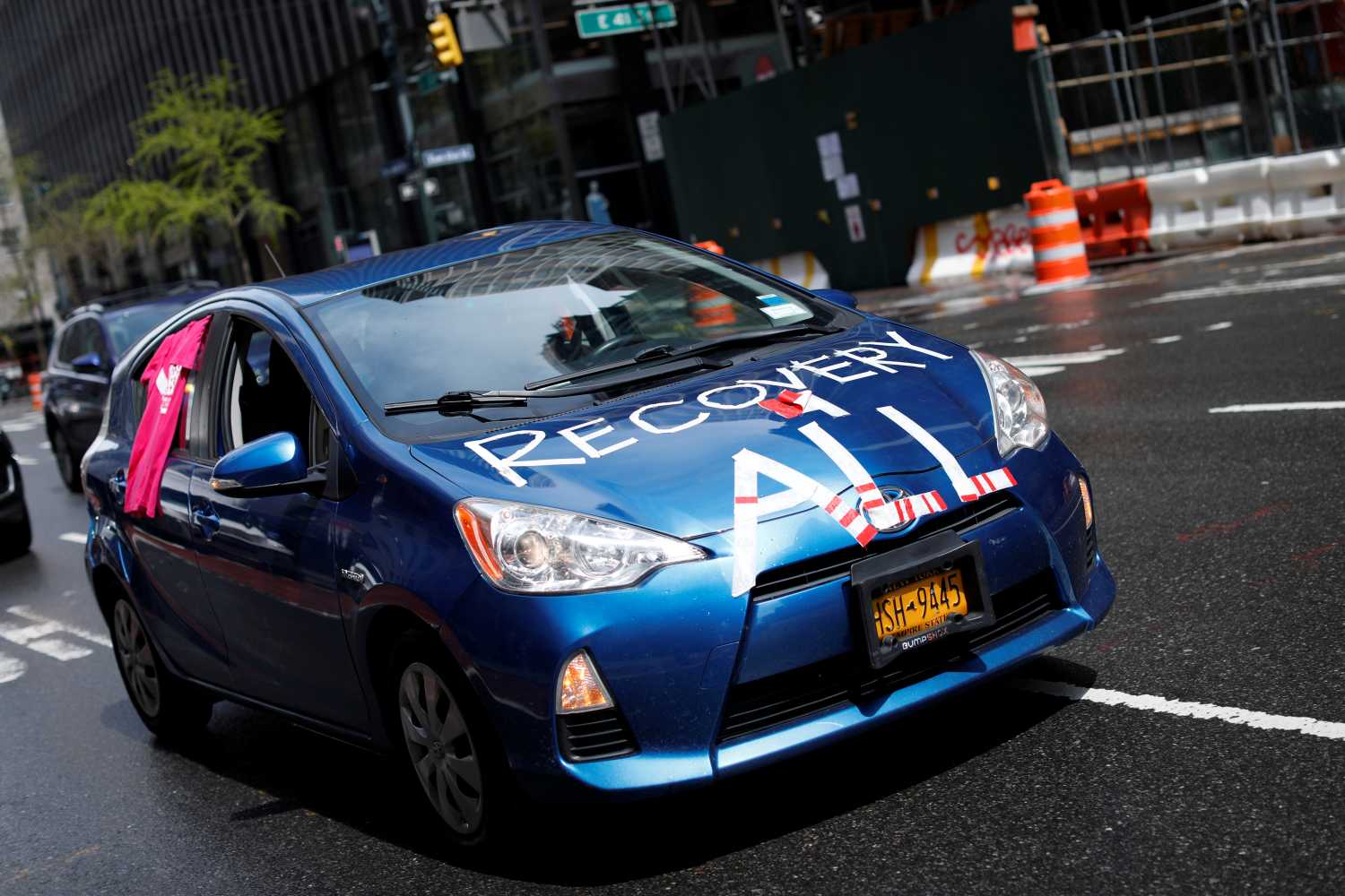 A car drives in a caravan during a demonstration in midtown Manhattan organized by the New York-based 'Workers Justice Project', protesting for rights of essential immigrant workers in the State of New York during the outbreak of the coronavirus disease (COVID-19) in New York City, New York, U.S., April 21, 2020. REUTERS/Mike Segar