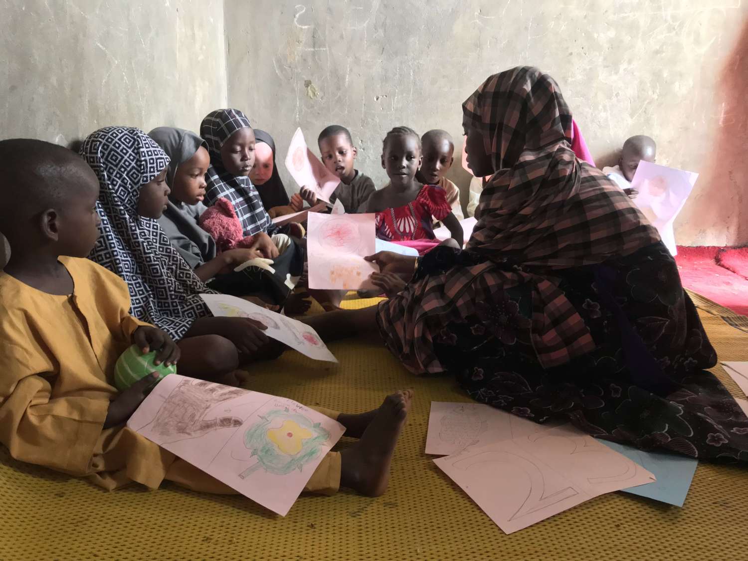 Student teacher with kids at home/school (credits: dRPC, Kano December 2019)