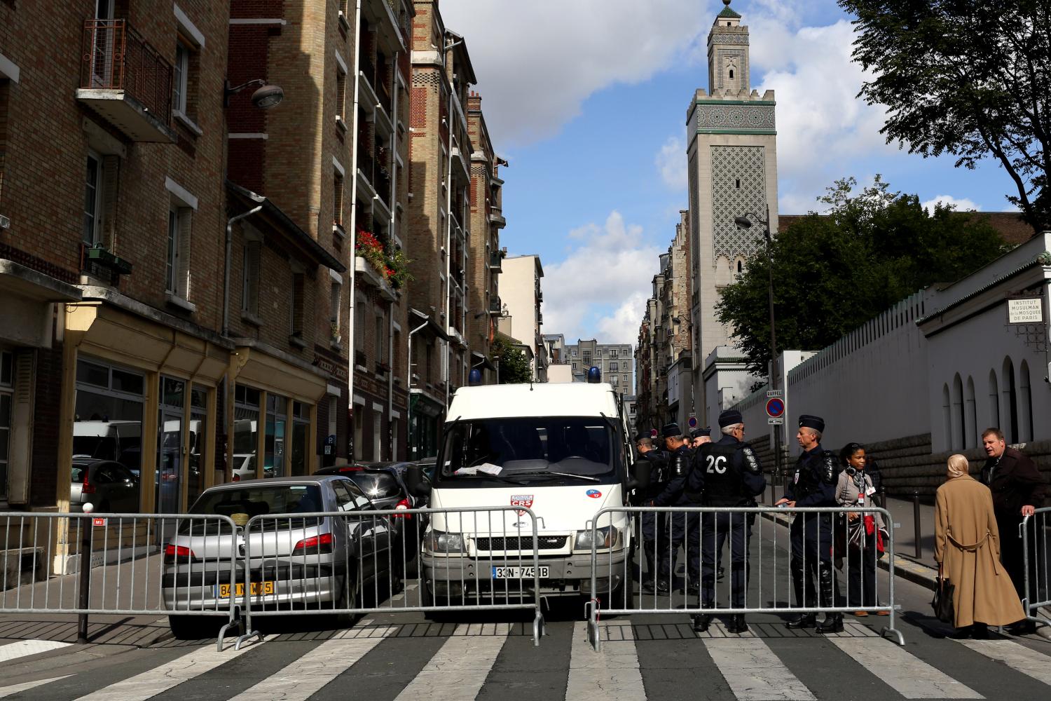 Anti-riot policemen stand in front of the Mosque, as police was deployed in several areas of the city to enforce a ban on protests over an anti-Islam film or against a French magazine that published cartoons mocking the Prophet Mohammed. France's Muslim leaders, on September 21, urged militants not to defy the ban on protests, as a security alert closed the France's embassies across the Islamic world, in Paris, France, on September 22, 2012. Photo by Stephane Lemouton/ABACAPRESS.COM.