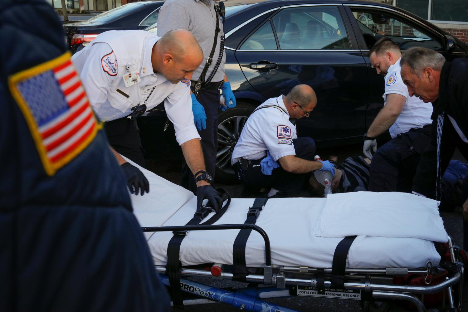 Cataldo Ambulance medics Rick Yunker (L), Derek Travers (C) and Timothy Stahl revive a 38-year-old man who was found unresponsive after an opioid overdose in the parking lot of a Walgreens drug store in the Boston suburb of Malden, Massachusetts, U.S., October 19, 2017. The man was revived with 4mg of naloxone. REUTERS/Brian Snyder  SEARCH "SNYDER OPIOIDS" FOR THIS STORY. SEARCH "WIDER IMAGE" FOR ALL STORIES.