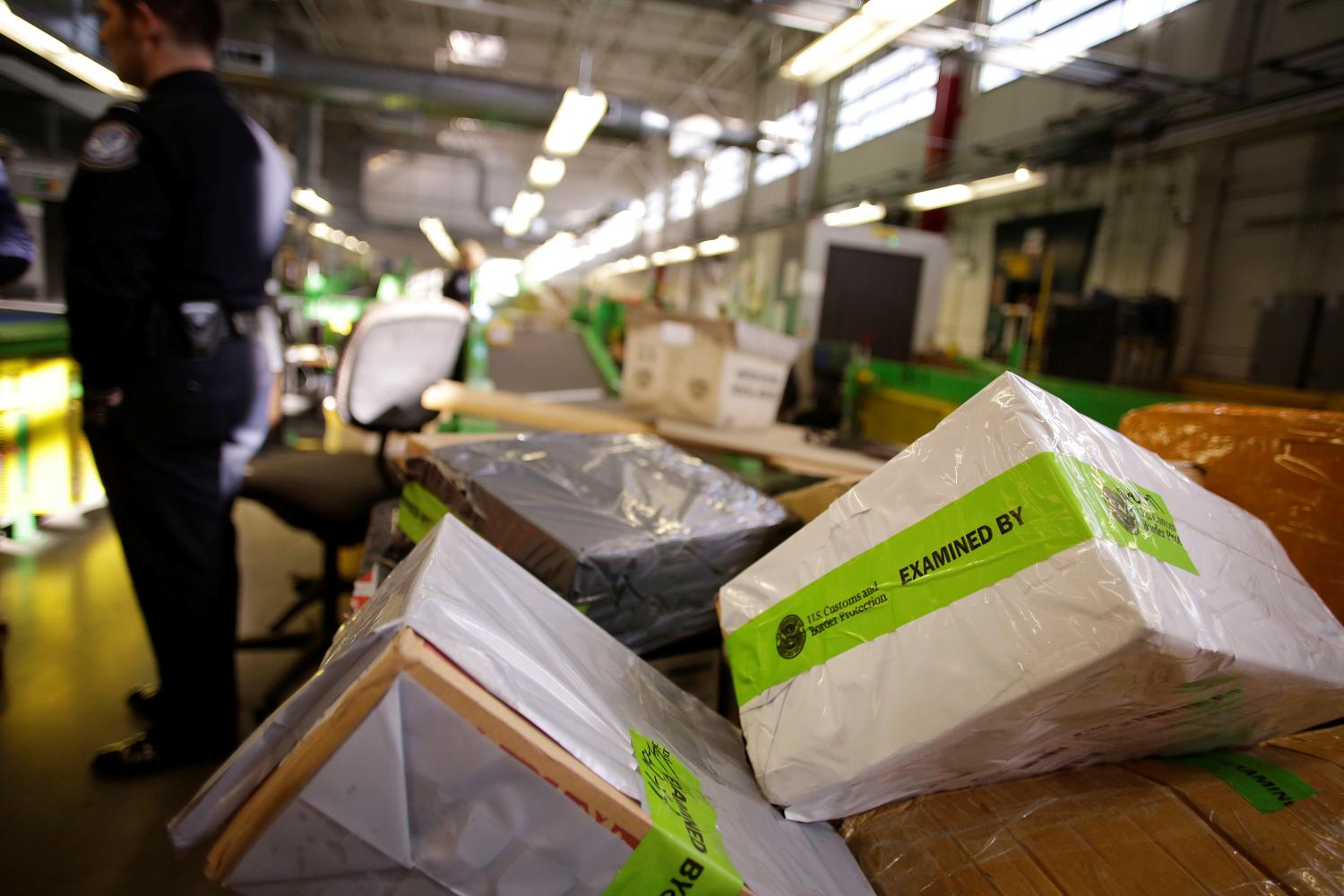 Packages already inspected by U.S. Customs and Border Protection officers sit in orange bins at the International Mail Facility at O'Hare International Airport in Chicago, Illinois, U.S. November 29, 2017. Picture taken November 29, 2017. REUTERS/Joshua Lott