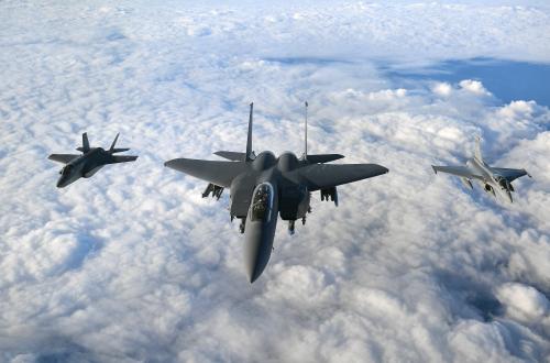 (left to right) An RAF F-35B Lightning stealth jet, a United States Air Force F-15 Strike Eagle and a French Air Force Rafale fly in formation over the English Channel during Operation Point Blank.
