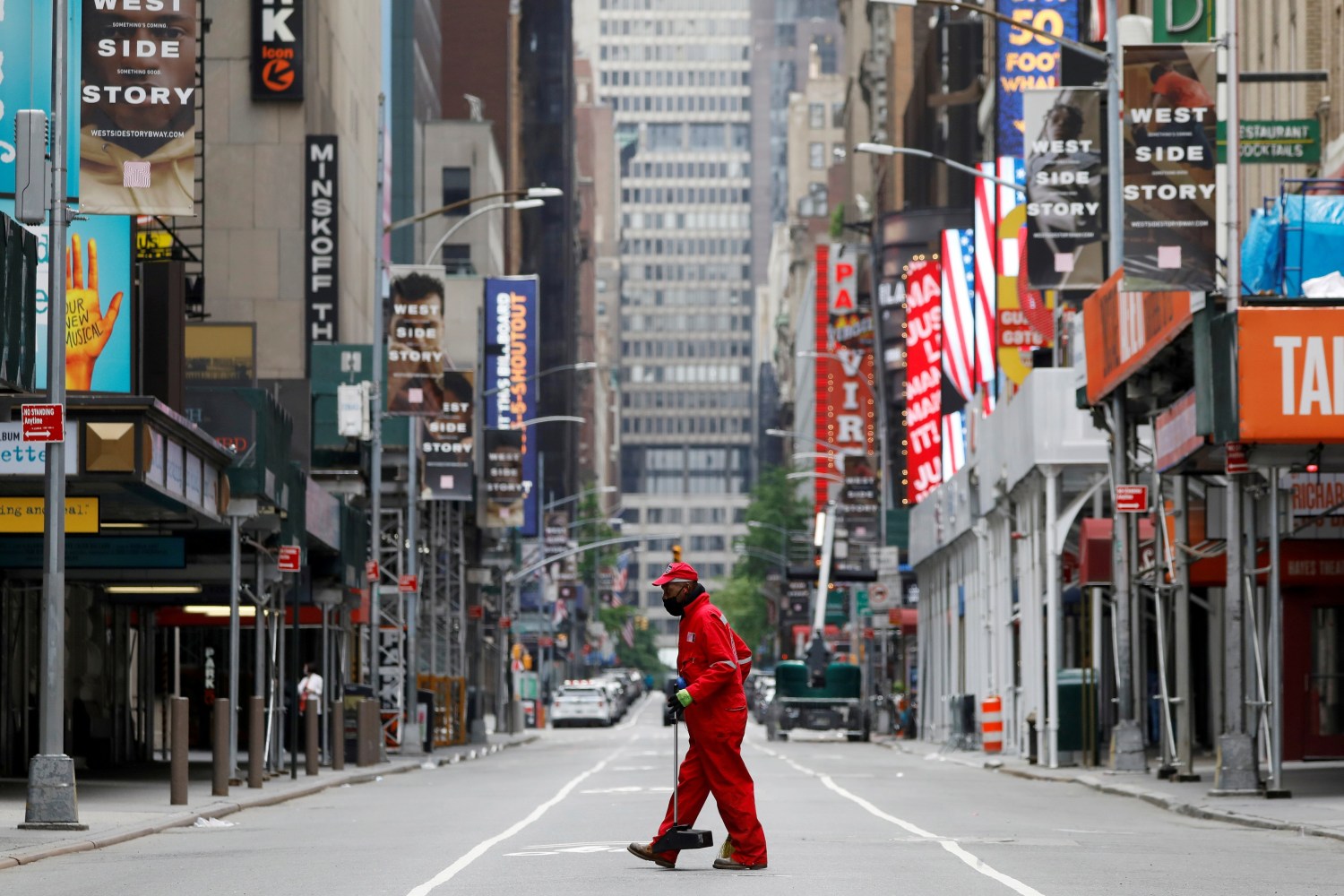FILE PHOTO: A street cleaner walks through the closed Broadway theatre district near Times Square following the outbreak of the coronavirus disease (COVID-19) in Manhattan, New York City, U.S., May 24, 2020. REUTERS/Andrew Kelly/File Photo