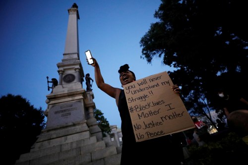 A protester speaks to the crowd underneath a Confederate monument during nationwide unrest following the death in Minneapolis police custody of George Floyd, in Raleigh, North Carolina, U.S. May 31, 2020. Picture taken May 31, 2020. REUTERS/Jonathan Drake     TPX IMAGES OF THE DAY