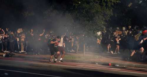 Protestors run as riot police fire tear gas and move on demonstrators to clear Lafayette Park and the area around it across from the White House for President Donald Trump to be able to walk through for a photo opportunity in front of St. John's Episcopal Church, during a rally against the death in Minneapolis police custody of George Floyd, near the White House, in Washington, U.S. June 1, 2020. REUTERS/Ken Cedeno     TPX IMAGES OF THE DAY