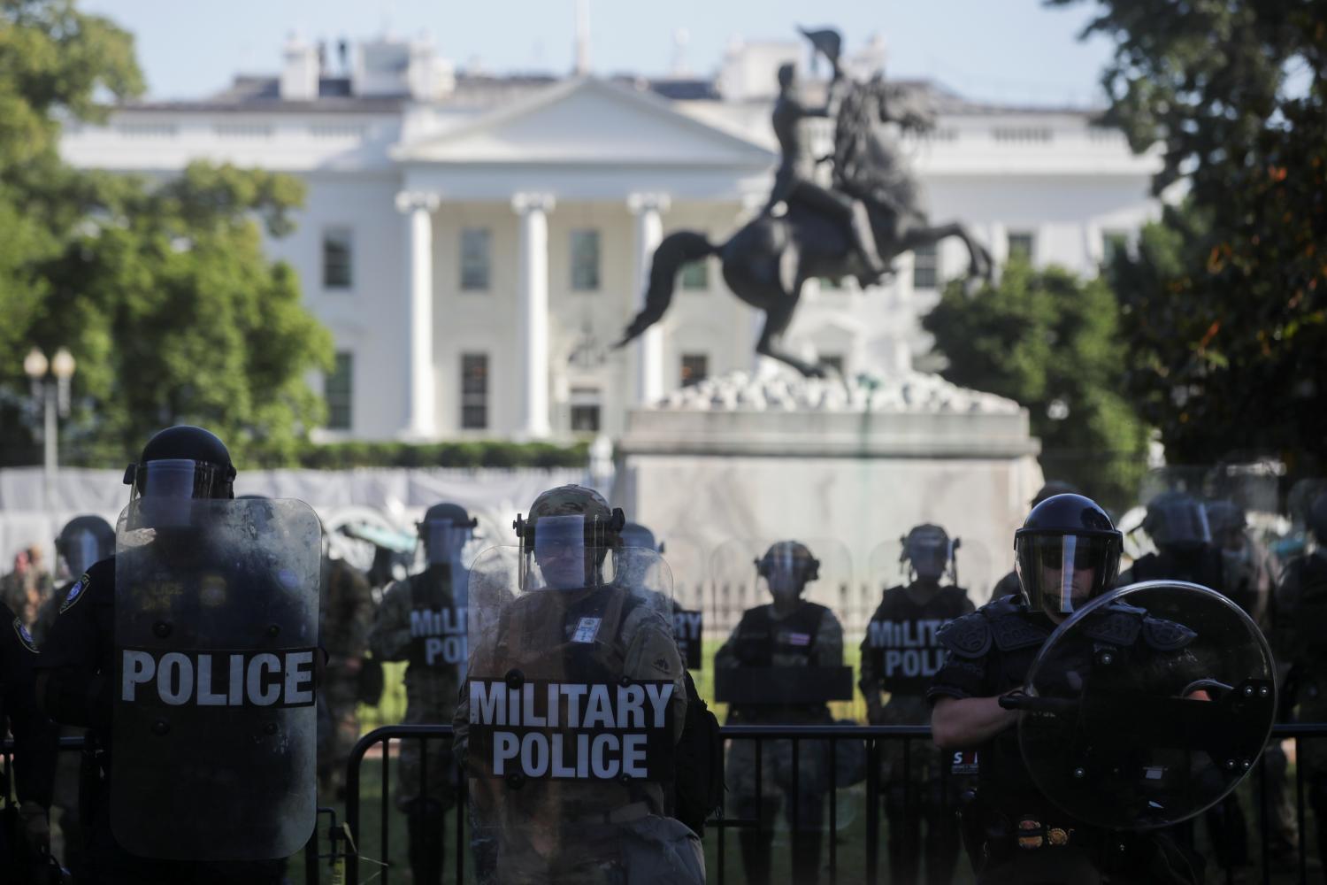 FILE PHOTO: DC National Guard military police officers look on as demonstrators rally near the White House against the death in Minneapolis police custody of George Floyd, in Washington, D.C., U.S., June 1, 2020. REUTERS/Jonathan Ernst/File Photo