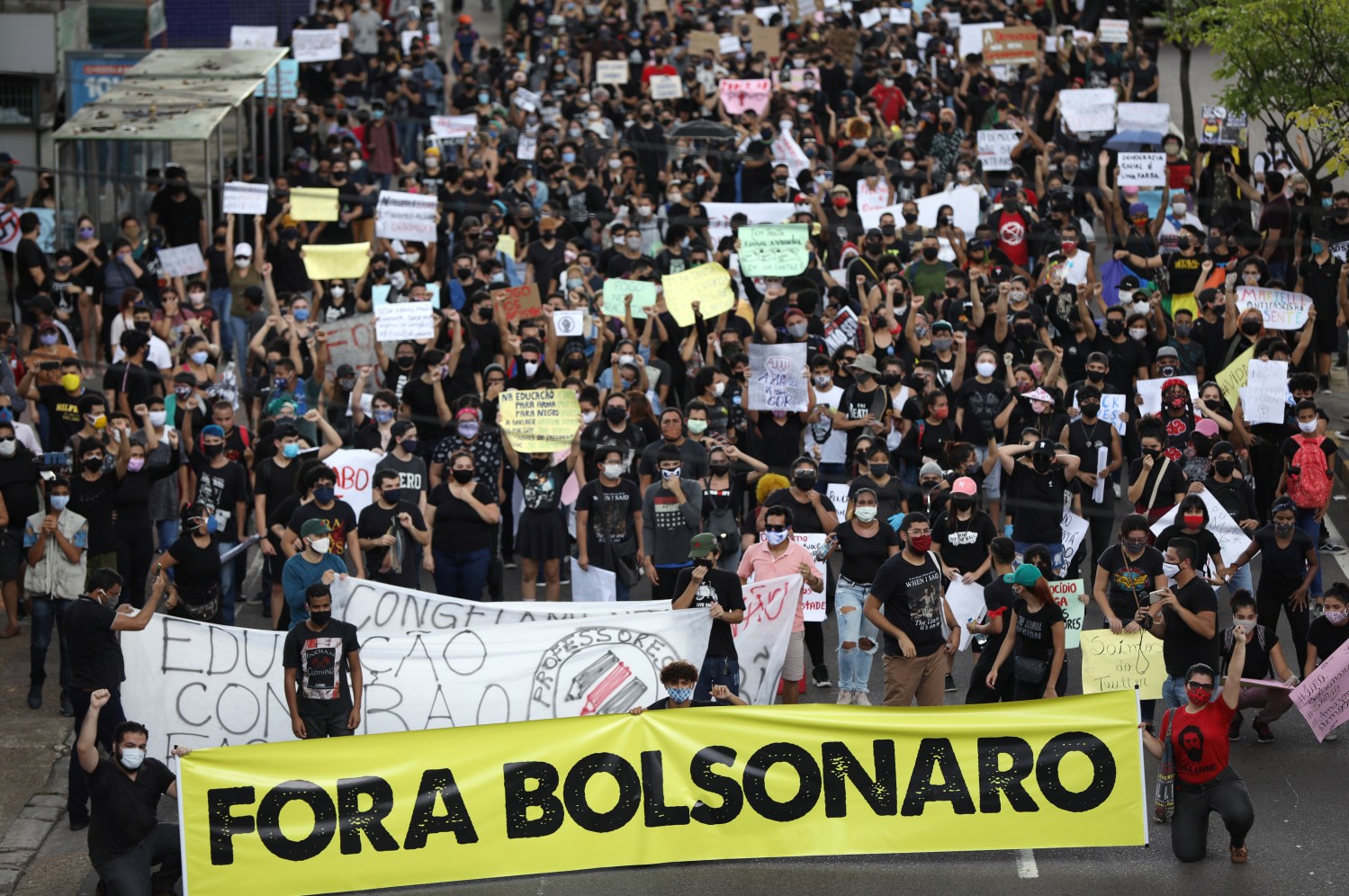 Anti-government demonstrators hold a banner that reads "Out Bolsonaro," in reference to Brazilian President Jair Bolsonaro, during a protest named "Amazonas for Democracy" in Manaus, Brazil, June 2, 2020. REUTERS/Bruno Kelly