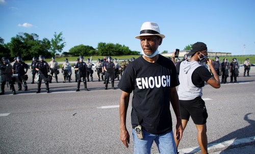 Man wearing an Enough shirt during a protest against the death in Minneapolis police custody of  George Floyd, in St. Charles, Missouri, U.S. June 6, 2020. REUTERS/Lawrence Bryant
