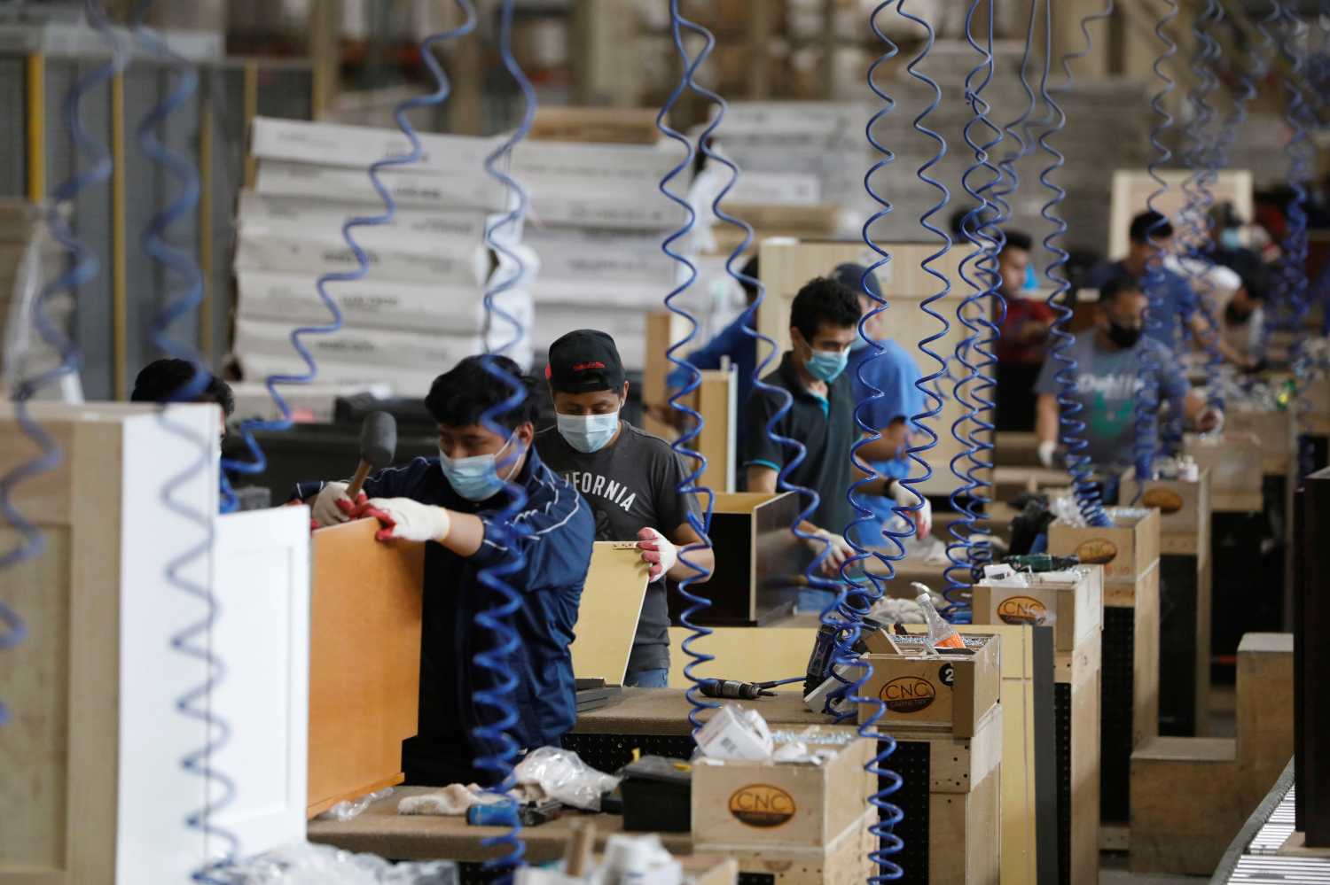 Workers assemble cabinets at CNC Cabinetry in South Plainfield, New Jersey, U.S., June 16, 2020. REUTERS/Andrew Kelly