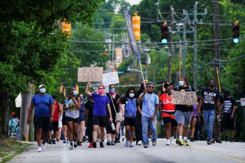 People take part in an event to mark Juneteenth, which commemorates the end of slavery in Texas, two years after the 1863 Emancipation Proclamation freed slaves elsewhere in the United States, amid nationwide protests against racial inequality, in Atlanta, Georgia, U.S. June 19, 2020. REUTERS/Elijah Nouvelage