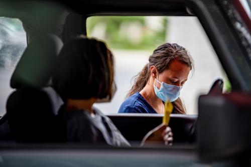 Atealla Betancourt speaks with a doctor before getting tested for the coronavirus disease (COVID-19) during its outbreak, in Austin, Texas, U.S., June 28, 2020. REUTERS/Sergio Flores