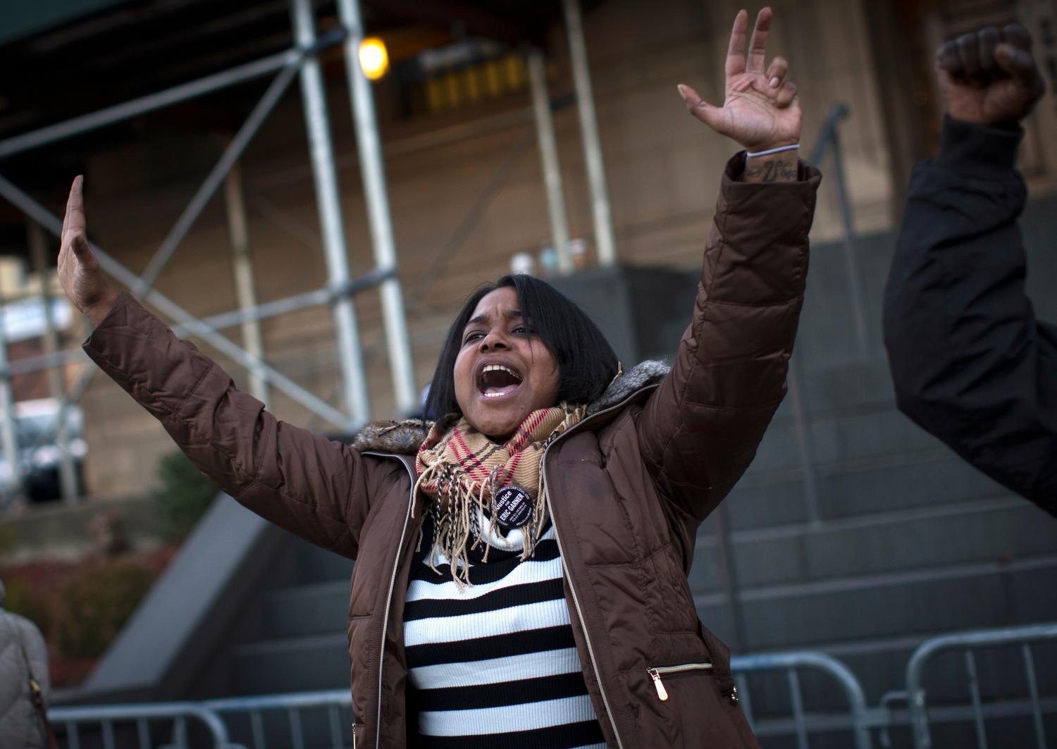 Erica Garner, the daughter of Eric Garner leads a chant at a protest and candlelight vigil outside the 120th police precinct in the Staten Island borough of New York City, January 15, 2015. Protests were organized to coincide with Martin Luther King Jr's birthday and have been ongoing in New York since last year's shooting death of Michael Brown in Ferguson, Missouri and Eric Garner's chokehold death in Staten Island, New York. Both deaths were at the hands of local police forces and in both instances, charges were not laid for the deaths. REUTERS/Mike Segar (UNITED STATES - Tags: CRIME LAW CIVIL UNREST)