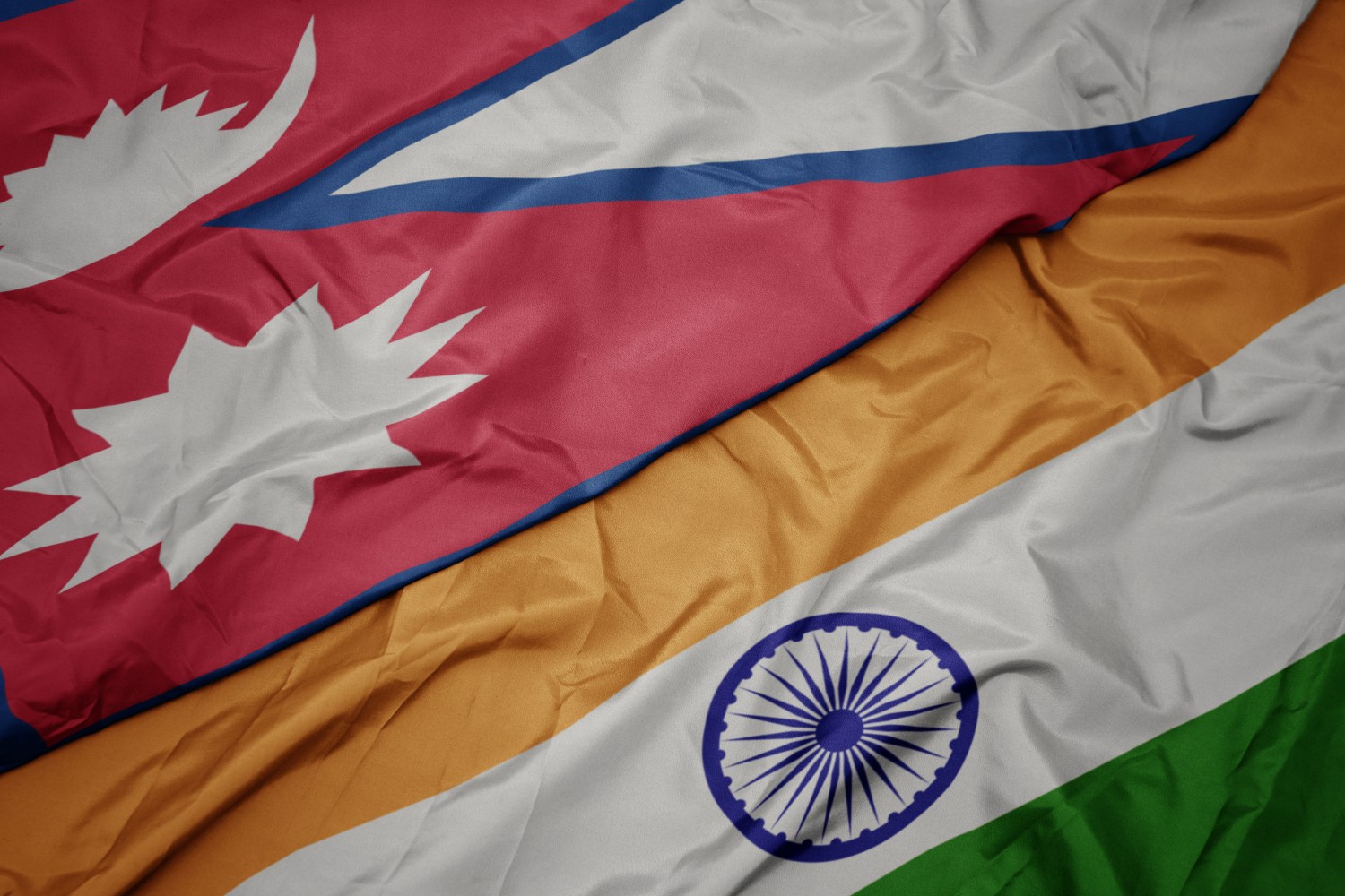 waving colorful flag of india and national flag of nepal. macro