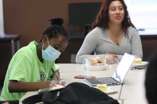 A handful of students remain on campus at Monroe Community College, Friday, May 15, 2020.  The college allows students who don't have a residence to go back to or live too far away to remain living on campus.  Nights Asefa of Greece works on homework while Danniela Morales who lives in Jamaica in the Queens borough of NYC, eats a cupcake.  Asefa, who will attend SUNY Albany in the fall said, "I hope everything goes back to normal," and that they can see each other face to face.Rochester Coronavirus Mcc Students Reopen Rochester Two Girls