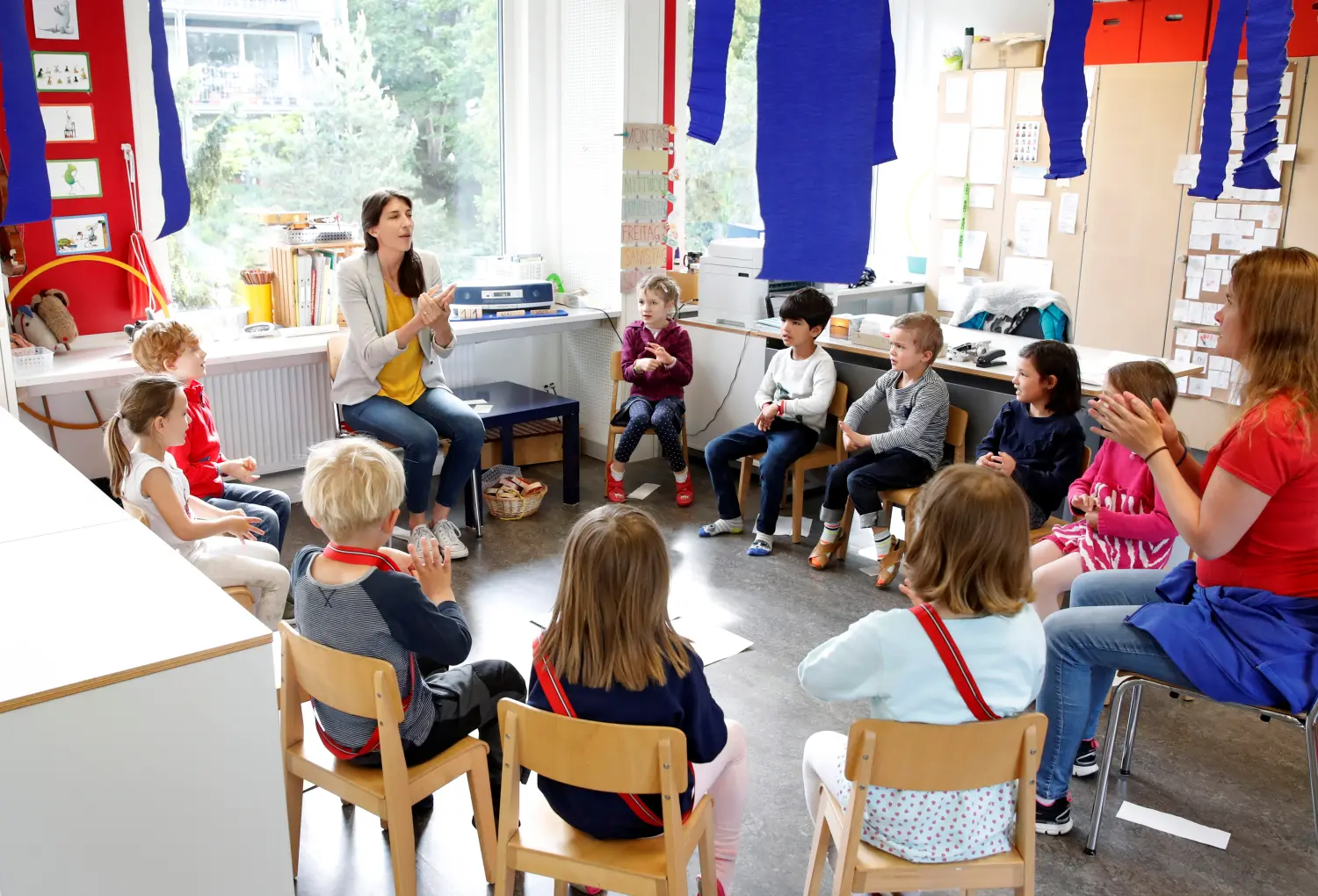 Children listen to the explanations of teacher Angela Melad on how to wash their hands at the KiGa Hutten kindergarten during the first day back as Switzerland eases the lockdown measures during the coronavirus disease (COVID-19) outbreak in Zurich, Switzerland May 11, 2020. REUTERS/Arnd Wiegmann