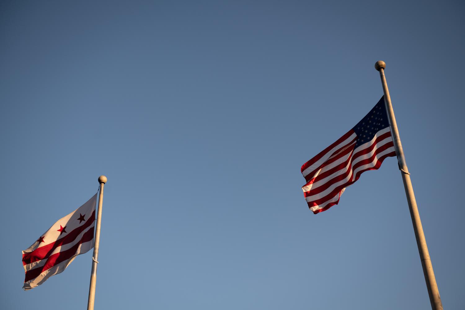 The American Flag and the District of Columbia Flag fly side-by-side in Washington, D.C., on Wednesday, April 8, 2020, as seen amid the global coronavirus outbreak. As confirmed cases reached 1.5 million world wide, with more than 400,000 in the U.S. alone, press reports have revealed a lagging response by the Trump Administration in the early days of the outbreak. (Graeme Sloan/Sipa USA)No Use UK. No Use Germany.