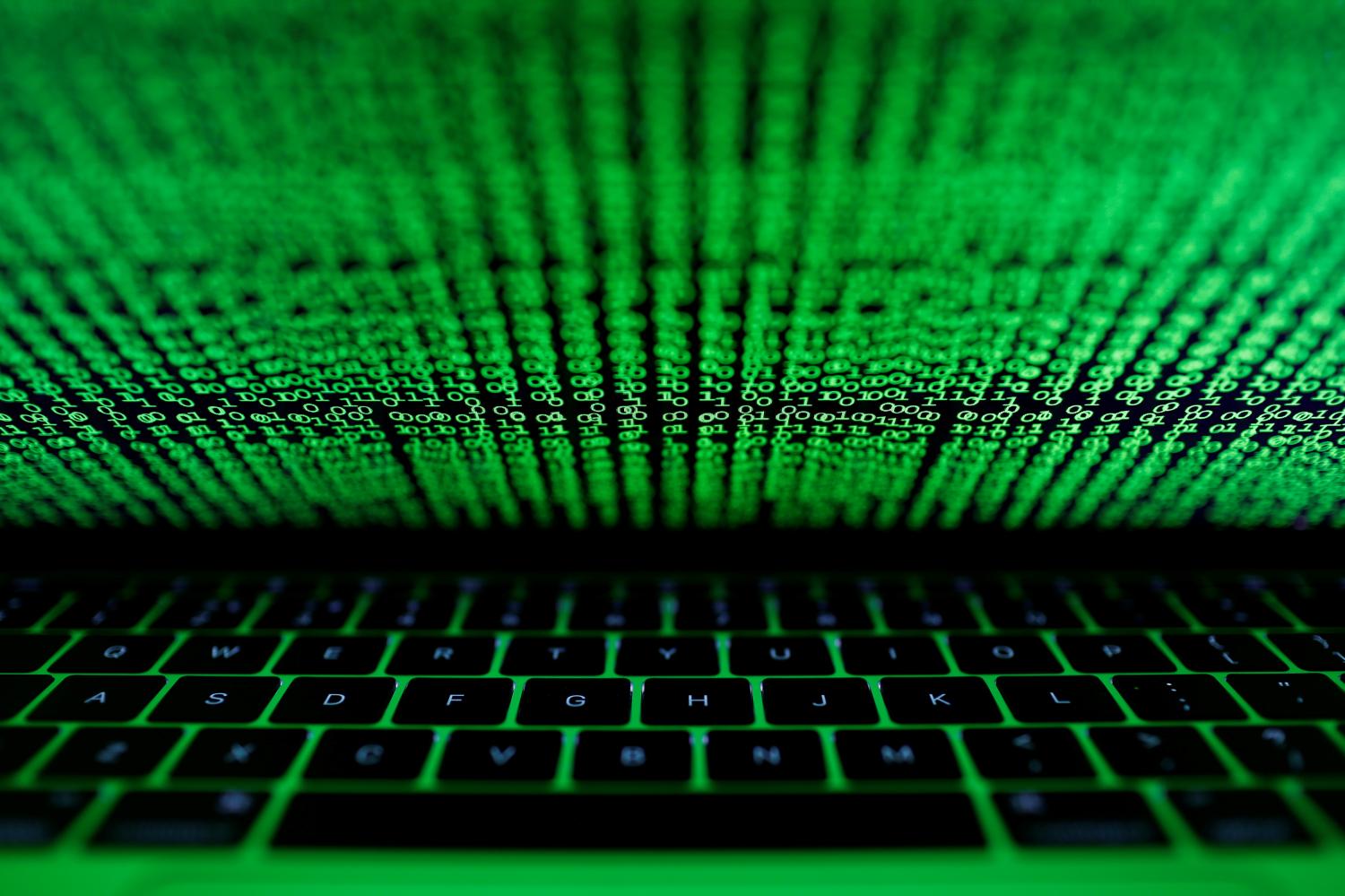 FILE PHOTO: A computer keyboard lit by a displayed cyber code is seen in this illustration picture taken on March 1,  2017. REUTERS/Kacper Pempel/Illustration/File Photo