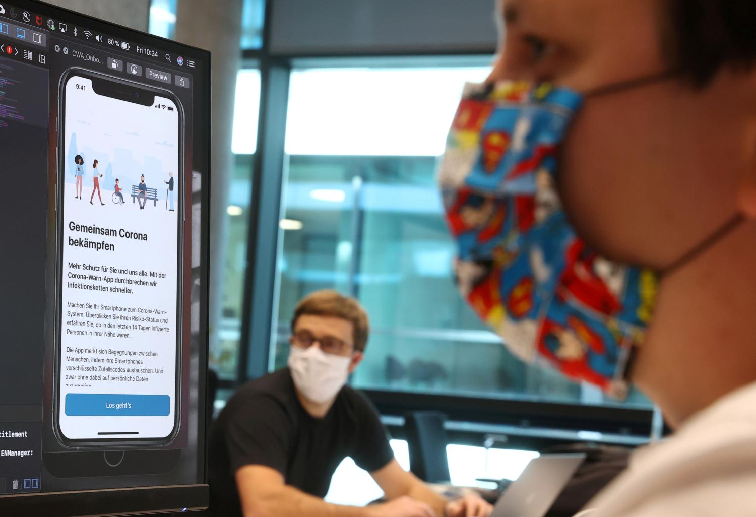 FILE PHOTO: Florian Heretsch and Emil Voutta of the developing team of software giant SAP work on the German government official COVID-19 tracing App at the SAP headquarters, as the spread of the coronavirus disease (COVID-19) continues, in Walldorf, Germany May 29, 2020. REUTERS/Kai Pfaffenbach/File Photo