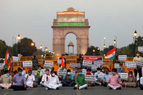 Supporters of India's ruling Bharatiya Jayanta Party (BJP) hold placards to protest against China while paying tributes to the Indian army soldiers killed in a border clash with Chinese troops in Ladakh region, at India Gate, in New Delhi, India, June 17, 2020. REUTERS/Anushree Fadnavis - RC23BH9Q7RR9