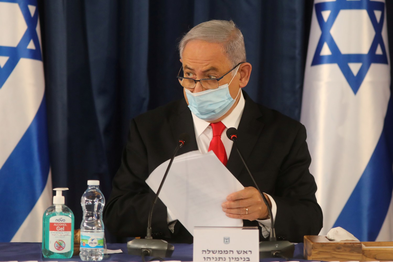 FILE PHOTO: Israeli Prime Minister Benjamin Netanyahu, wearing a protective mask due to the ongoing coronavirus disease (COVID-19) pandemic, chairs the weekly cabinet meeting in Jerusalem June 7, 2020. Menahem Kahana/Pool via REUTERS/File Photo