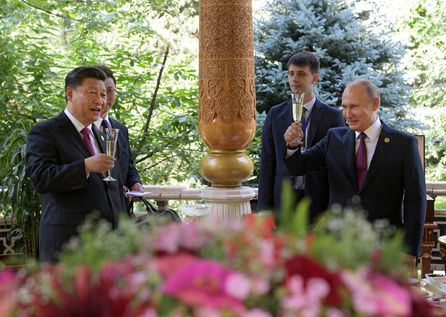 Russian President Vladimir Putin (R) toasts with Chinese President Xi Jinping while congratulating him on his birthday before the Conference on Interaction and Confidence-Building Measures in Asia (CICA) in Dushanbe, Tajikistan June 15, 2019. Sputnik/Alexei Druzhinin/Kremlin via REUTERS.