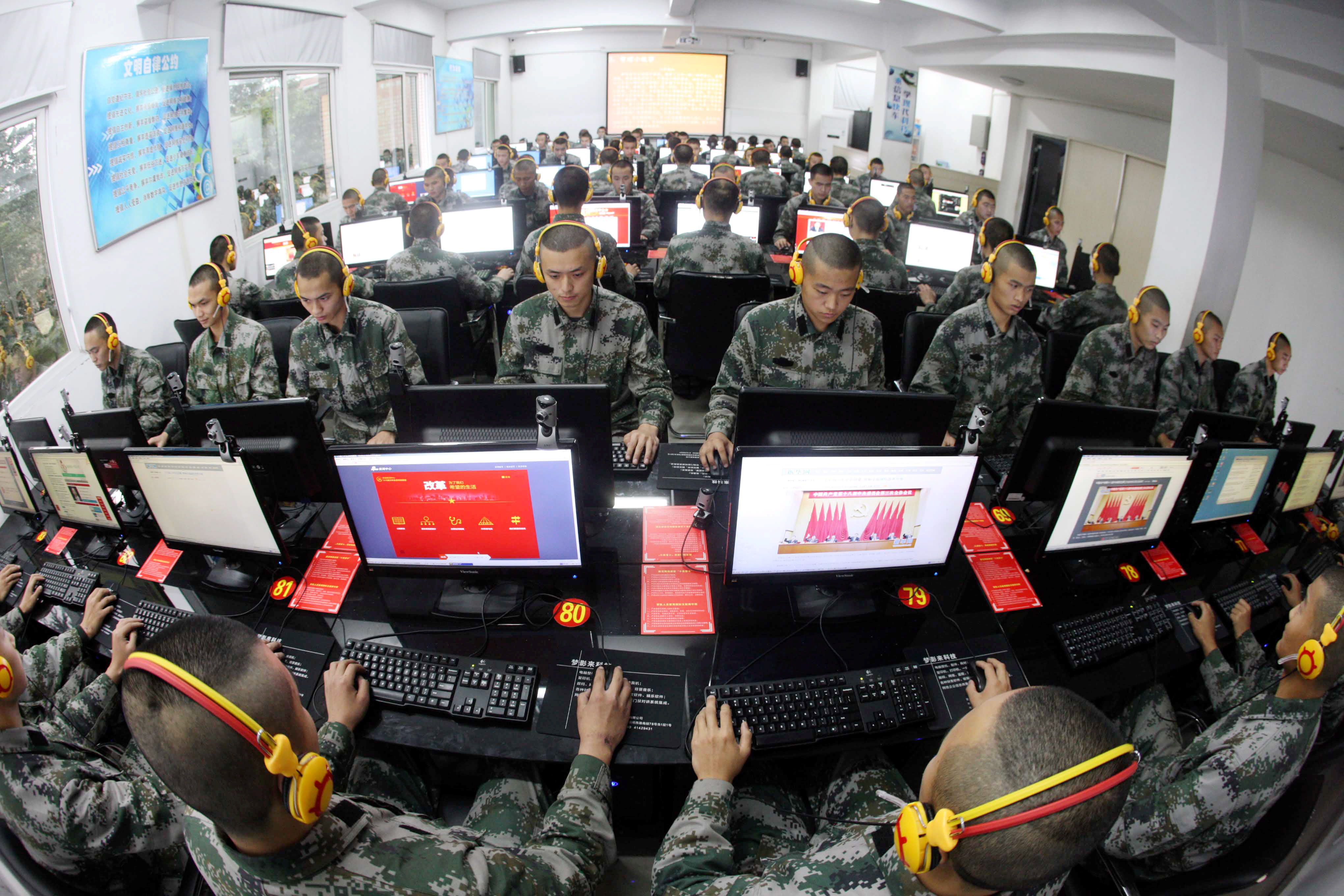 --FILE--Chinese soldiers browse online news on desktop computers at a garrison of the PLA (People's Liberation Army) in Chongqing, China, 14 November 2013.

Chinese leaders have made the passage of a cybersecurity law a priority for this year, despite protests from the U.S. against the country's growing restrictions on technology firms. Zhang Dejiang, chairman of the standing committee of China's National People's Congress, said in a work report Sunday (8 March 2015) that formulating laws for cybersecurity, antiterrorism and national security were major tasks for 2015. The cybersecurity law, which official media had previously disclosed was in the works, is still being drafted. Details haven't been announced.No Use China. No Use France.