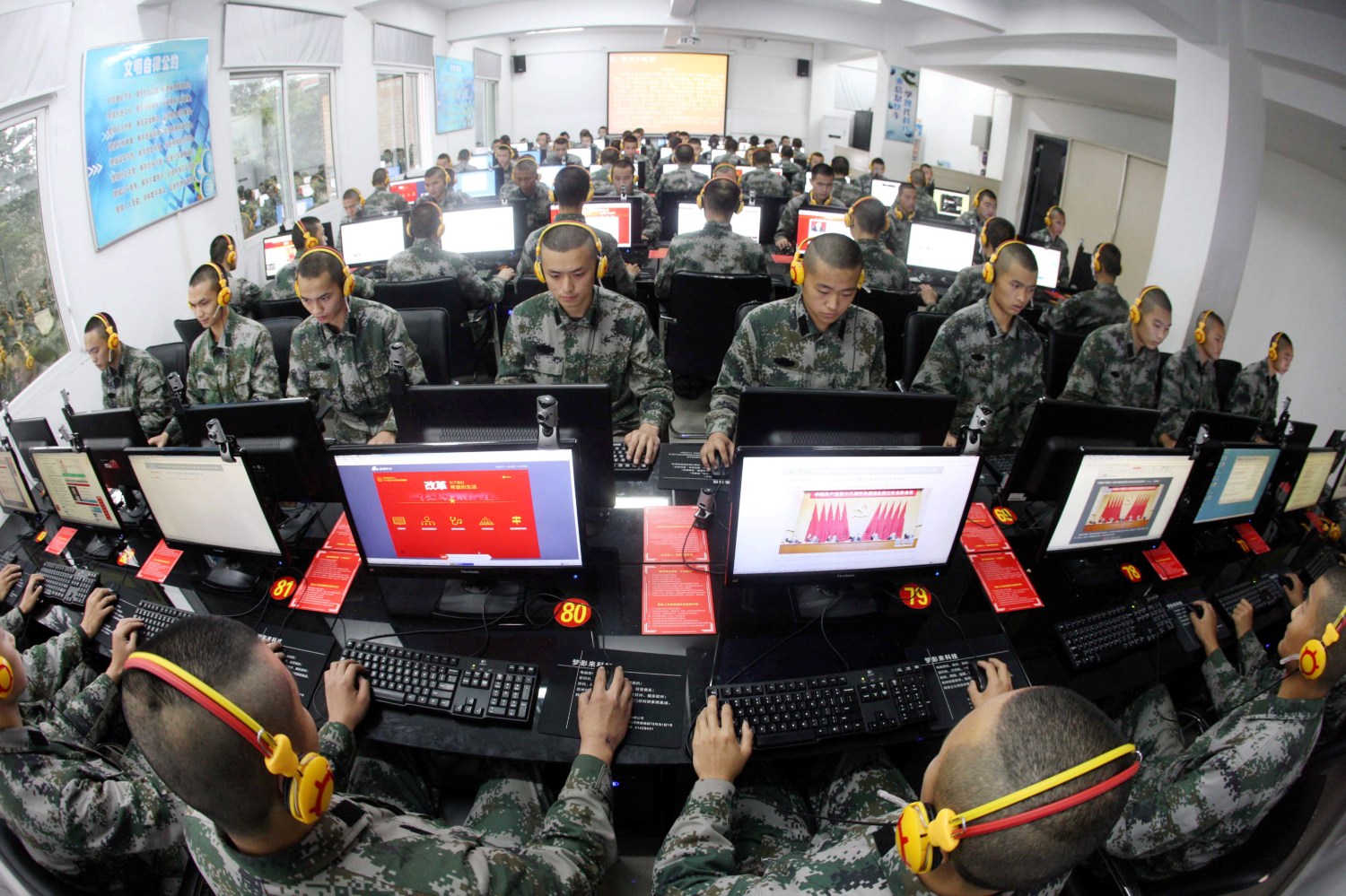 --FILE--Chinese soldiers browse online news on desktop computers at a garrison of the PLA (People's Liberation Army) in Chongqing, China, 14 November 2013.Chinese leaders have made the passage of a cybersecurity law a priority for this year, despite protests from the U.S. against the country's growing restrictions on technology firms. Zhang Dejiang, chairman of the standing committee of China's National People's Congress, said in a work report Sunday (8 March 2015) that formulating laws for cybersecurity, antiterrorism and national security were major tasks for 2015. The cybersecurity law, which official media had previously disclosed was in the works, is still being drafted. Details haven't been announced.No Use China. No Use France.