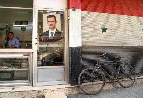 FILE PHOTO: A picture of Syrian President Bashar al-Assad is seen on a door of a butcher shop, during a lockdown to prevent the spread of the coronavirus disease (COVID-19), in Damascus, Syria April 22, 2020. Picture taken April 22, 2020. REUTERS/Yamam Al Shaar/File Photo