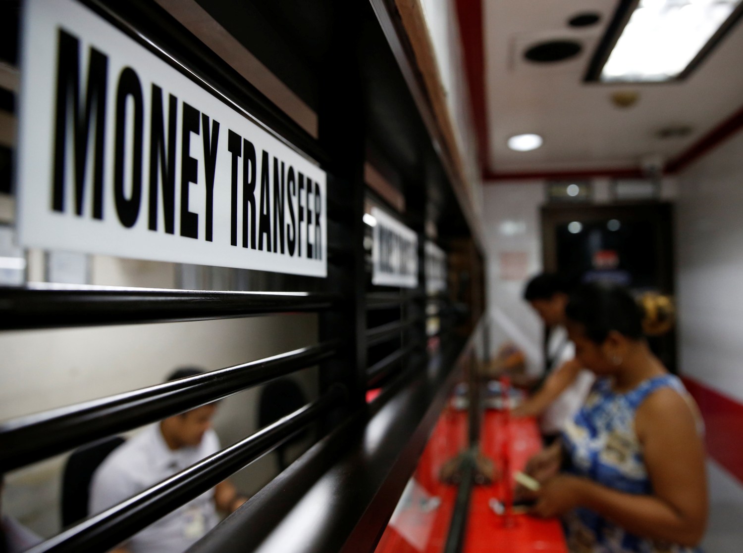 Customers receive money from families working abroad at a money remittance center in Makati City, Metro Manila, Philippines, September 19, 2018. REUTERS/Eloisa Lopez