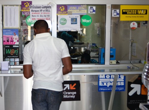 A customer at a money transfer point that offers money transfer services through Wari and other transfer companies in Dakar, Senegal March 15, 2017.  Picture taken March 15, 2017.  REUTERS/Nellie Peyton