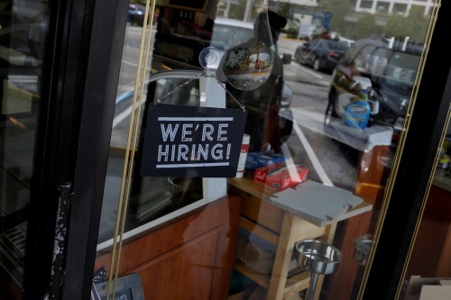 FILE PHOTO: A "We're Hiring" sign advertising jobs is seen at the entrance of a restaurant, as Miami-Dade County eases some of the lockdown measures put in place during the coronavirus disease (COVID-19) outbreak, in Miami, Florida, U.S., May 18, 2020. REUTERS/Marco Bello/File Photo