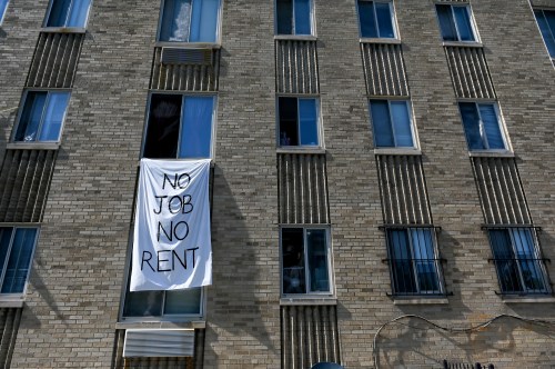 A banner hung by residents of the Meridian Heights apartment building calls for rent cancellation in the Columbia Heights neighborhood of Washington, U.S., May 25, 2020. REUTERS/Erin Scott