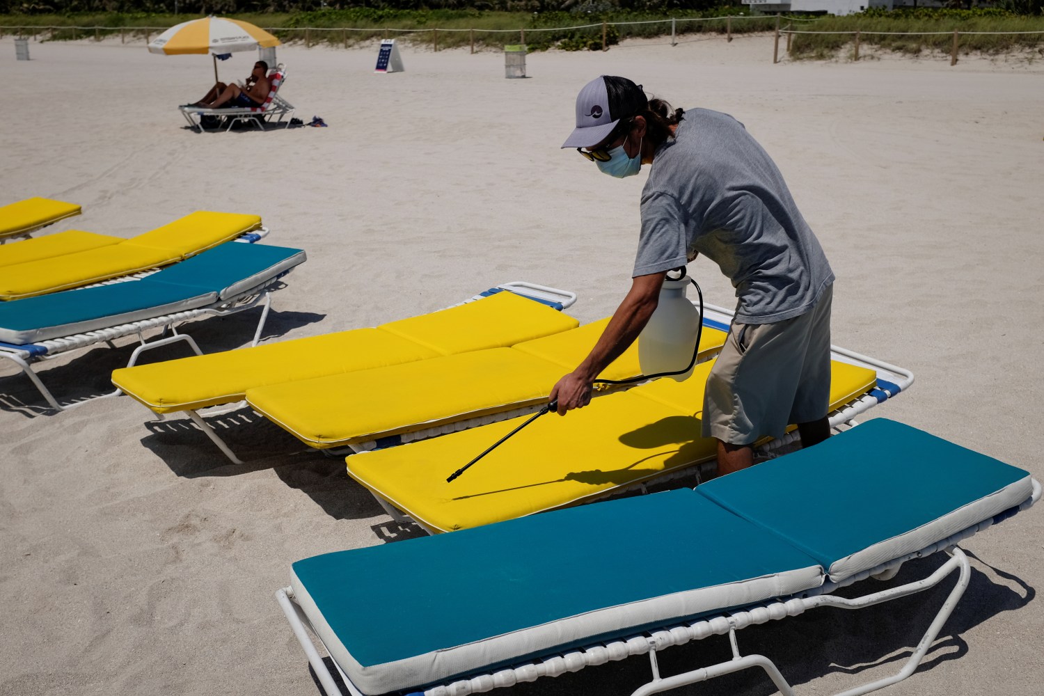 A worker sanitizes loungers as beaches are reopened with restrictions to limit the spread of the coronavirus disease (COVID-19), in Miami Beach, Florida, U.S., June 10, 2020. REUTERS/Marco Bello