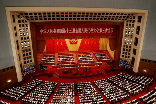 FILE PHOTO: Chinese officials and delegates attend the opening session of the National People's Congress (NPC) at the Great Hall of the People in Beijing, China May 22, 2020. REUTERS/Carlos Garcia Rawlins/File Photo