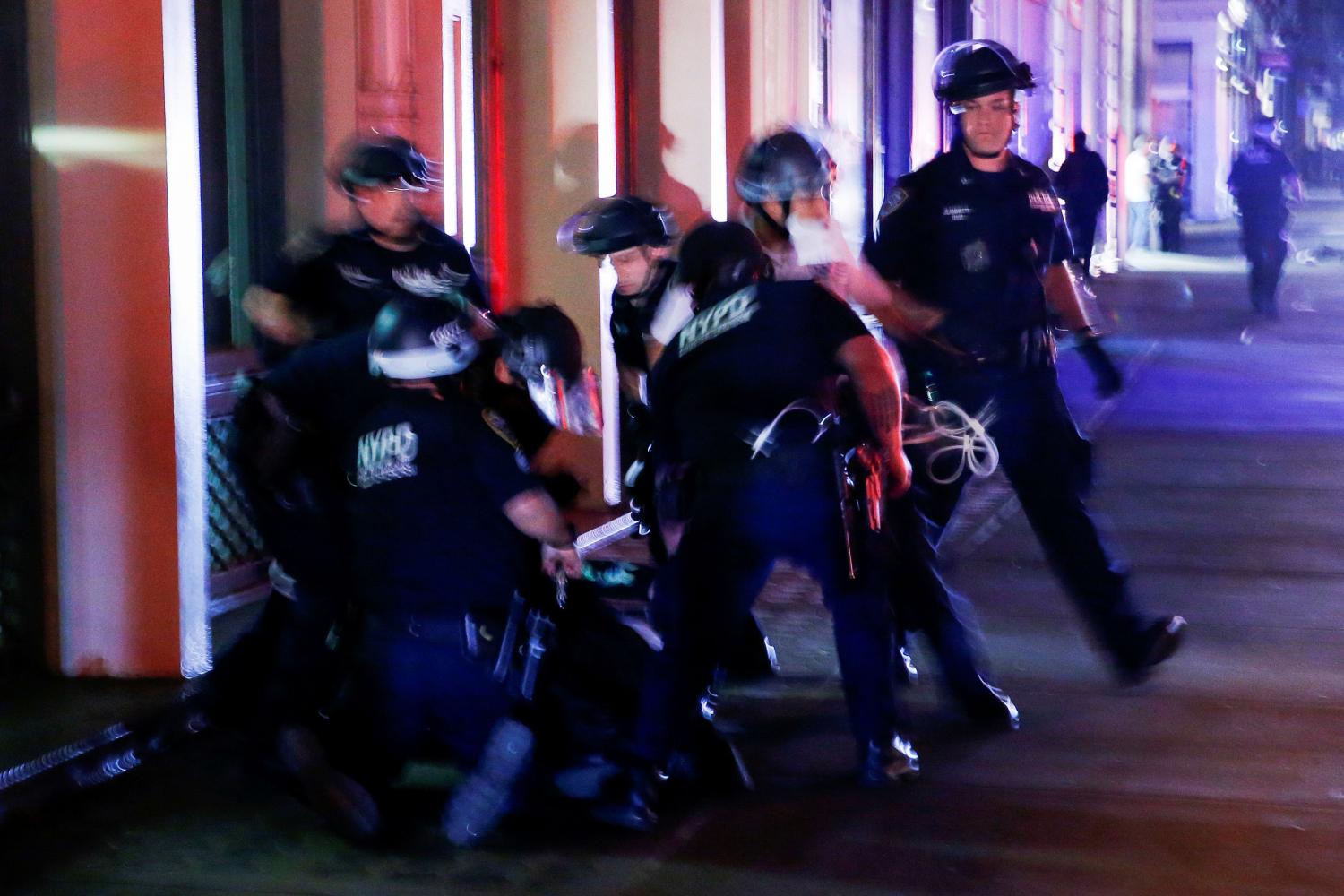 NYPD officers detain a protester who was looting in a store after marching against the death in Minneapolis police custody of George Floyd, in the Manhattan borough of New York City, U.S., June 2, 2020. REUTERS/Eduardo Munoz