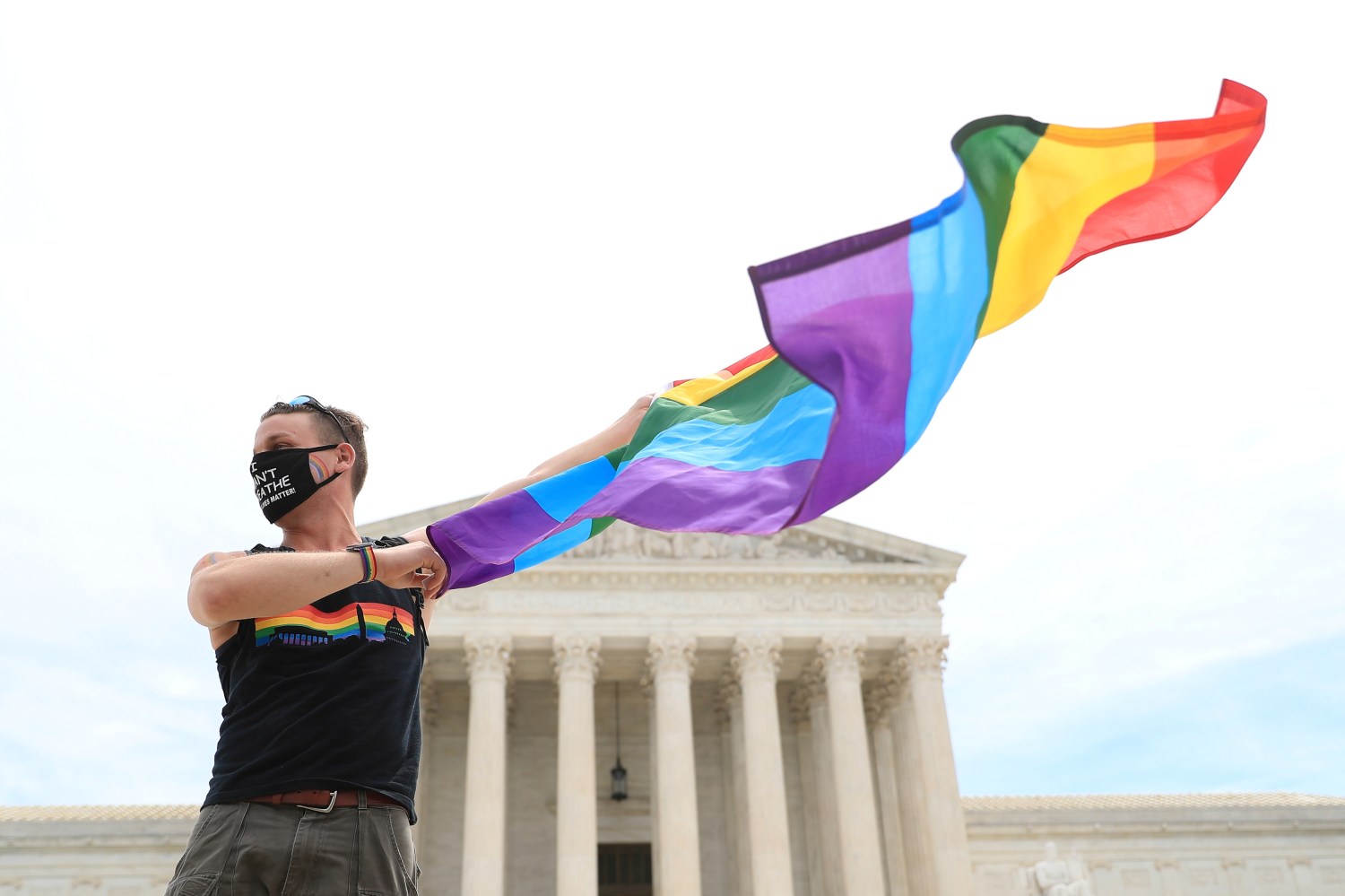 Joseph Fons holding a Pride Flag, stands in front of the U.S. Supreme Court building after the court ruled that a federal law banning workplace discrimination also covers sexual orientation, in Washington, D.C., U.S., June 15, 2020. REUTERS/Tom Brenner