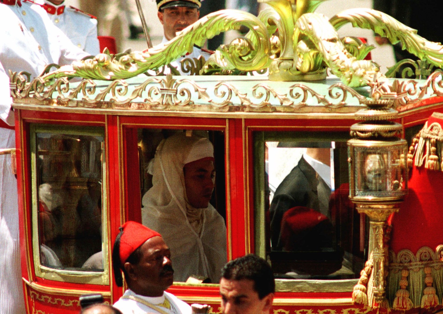 Morocco's new King Mohammed VI sits in a horse-drawn red carriage, on his way to preside over his first Moslem prayers at the Ahl Fez Mosque July 30, since taking the throne last week. According to tradition, the first Friday (after being crowned) the king presides over prayers as a symbol that the king is carrying out his role as the Commander of the Faithful.JB/AA