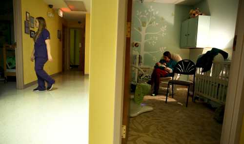 Lisa Collinsworth (R) holds her baby son Luke during a visit with him at Lily's Place, a treatment center for opioid-dependent newborns in Huntington, West Virginia, October 19, 2015.  Picture taken October 19, 2015. To match Special Report BABY-OPIOIDS/   REUTERS/Jonathan Ernst